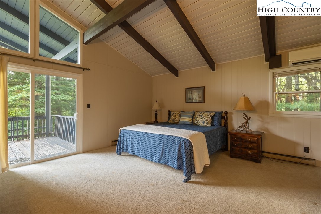 377 Deer Run Road Glade Valley, NC 28627 - Photo 16 of 26 a bed sitting in a room next to a window