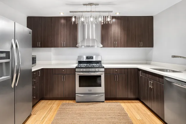 a kitchen with granite countertop a stove and a refrigerator