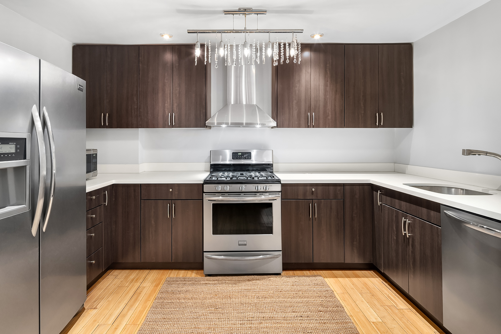 162 9th Avenue, Unit B Manhattan, NY 10035 - Photo 6 of 9 a kitchen with granite countertop a stove and a refrigerator