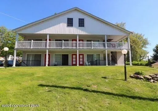 a front view of a house with a yard table and chairs