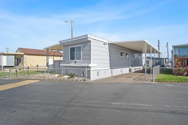 a front view of a house with a street