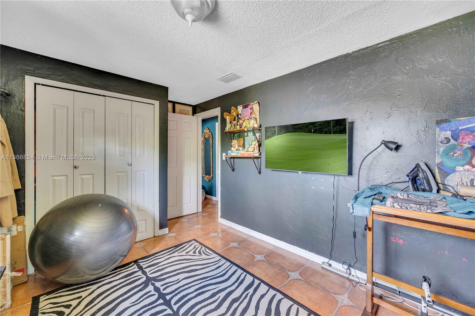 2729 Southwest 67th Avenue Miami, FL 33155 - Photo 21 of 37 a bedroom with a bed and a flat screen tv
