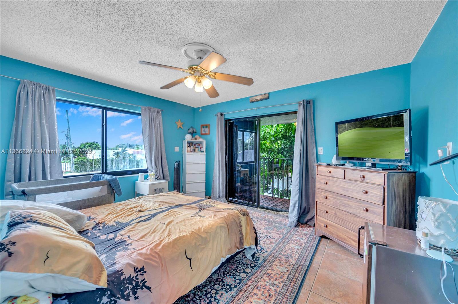 2729 Southwest 67th Avenue Miami, FL 33155 - Photo 28 of 37 a bedroom with a bed flat screen tv and a large window