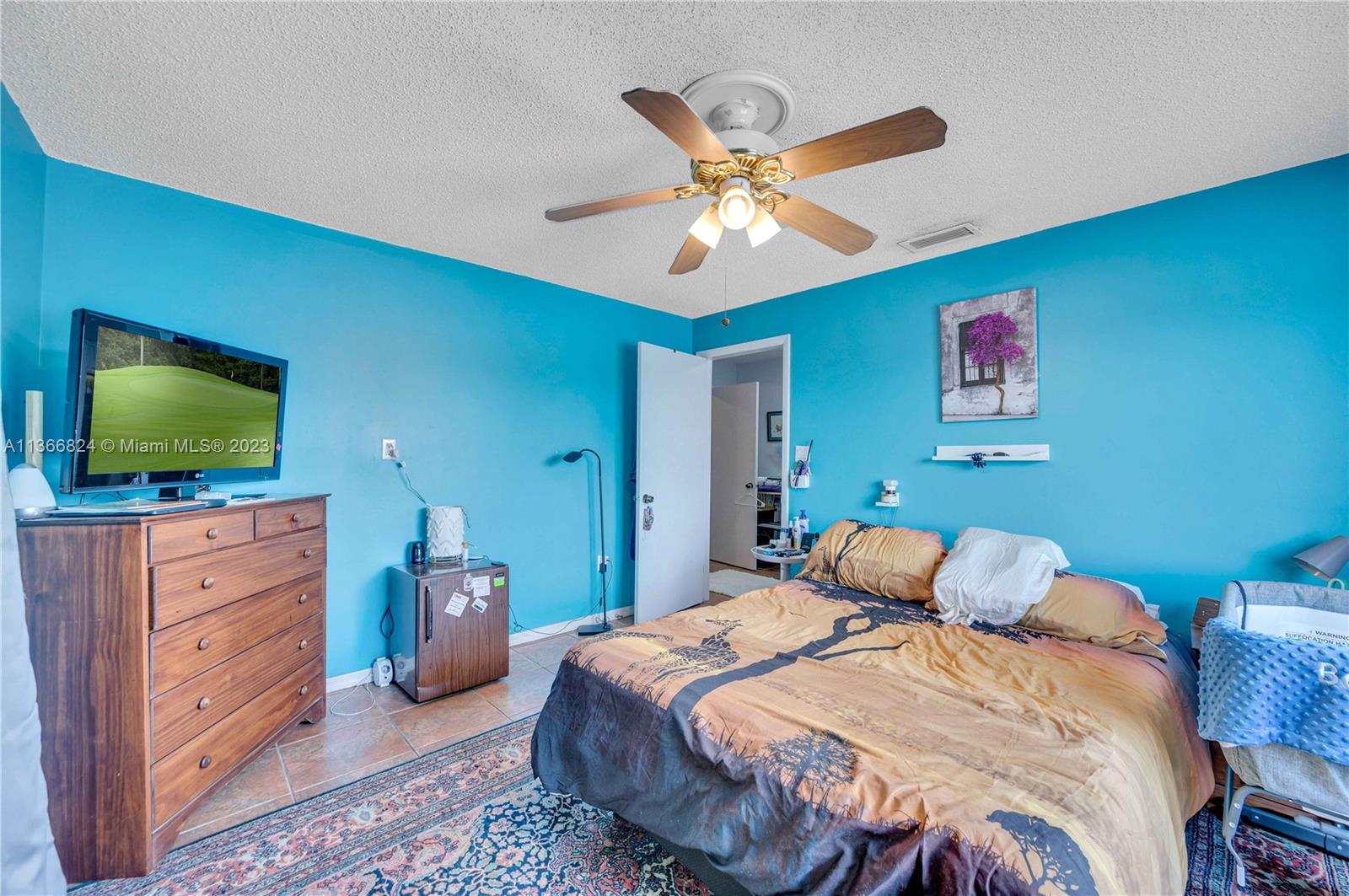 2729 Southwest 67th Avenue Miami, FL 33155 - Photo 29 of 37 a bedroom with a bed and a flat screen tv