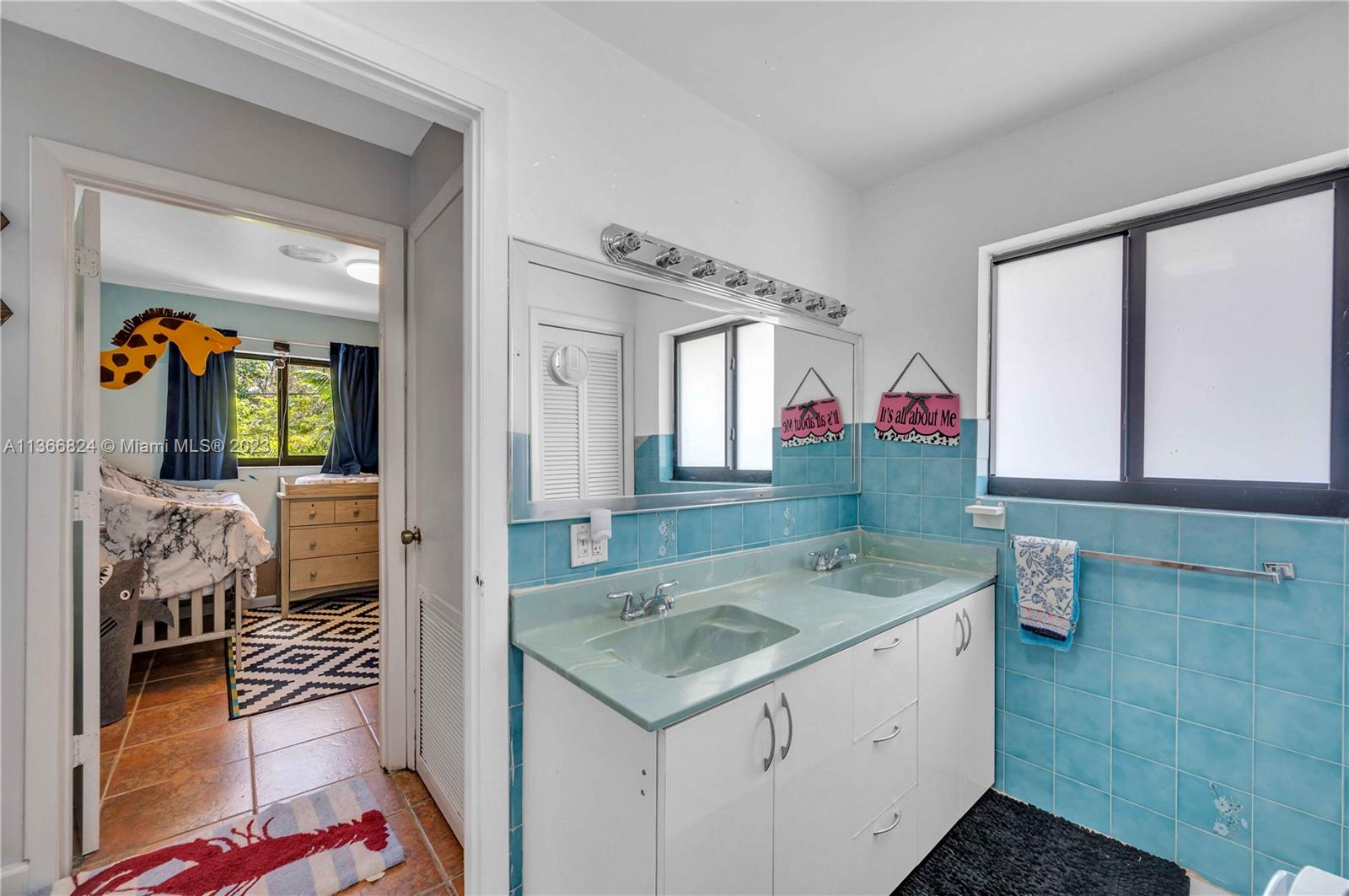 2729 Southwest 67th Avenue Miami, FL 33155 - Photo 33 of 37 a bathroom with a sink and a mirror