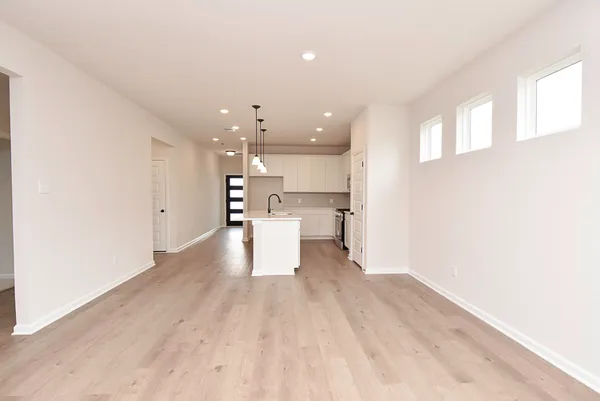 a view of a kitchen with a sink and wooden floor
