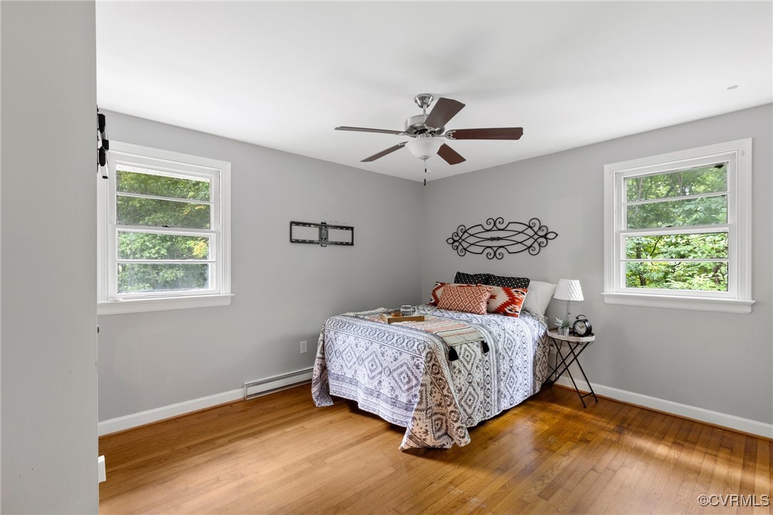 7716 Old Beach Road Chesterfield, VA 23838 - Photo 13 of 24 a bedroom with a bed a window and a chandelier