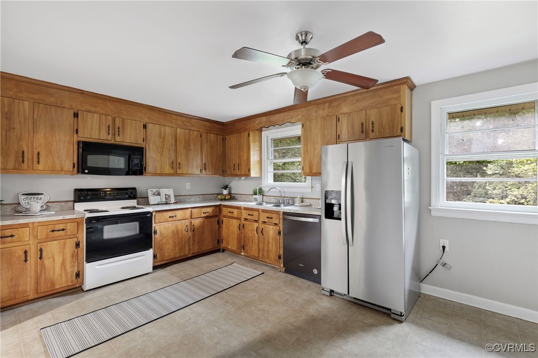 7716 Old Beach Road Chesterfield, VA 23838 - Photo 7 of 24 a kitchen with stainless steel appliances granite countertop a refrigerator a stove a sink a stove a oven with a dining table and chairs