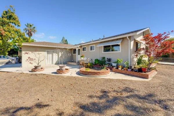 a front view of a house with yard and outdoor seating