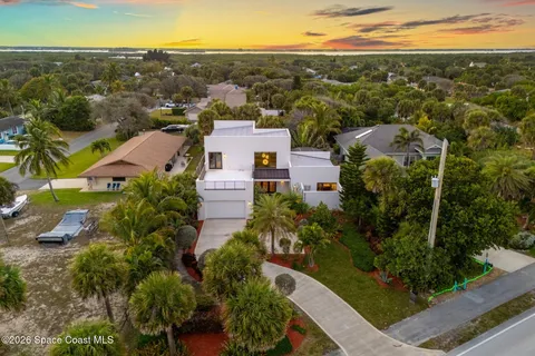 an aerial view of a house with yard