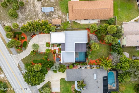 an aerial view of residential houses with outdoor space