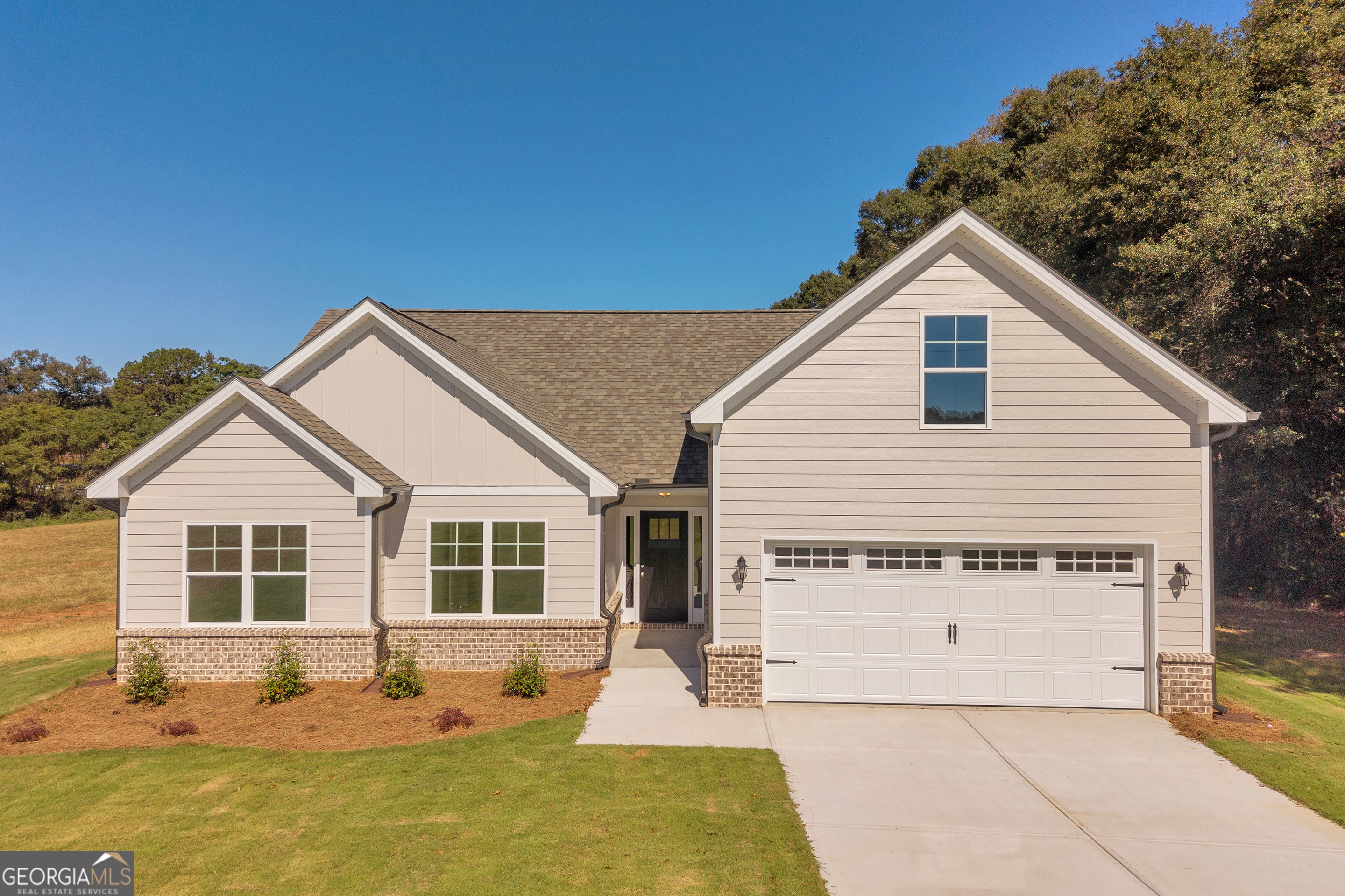 a view of a house with backyard and sitting area