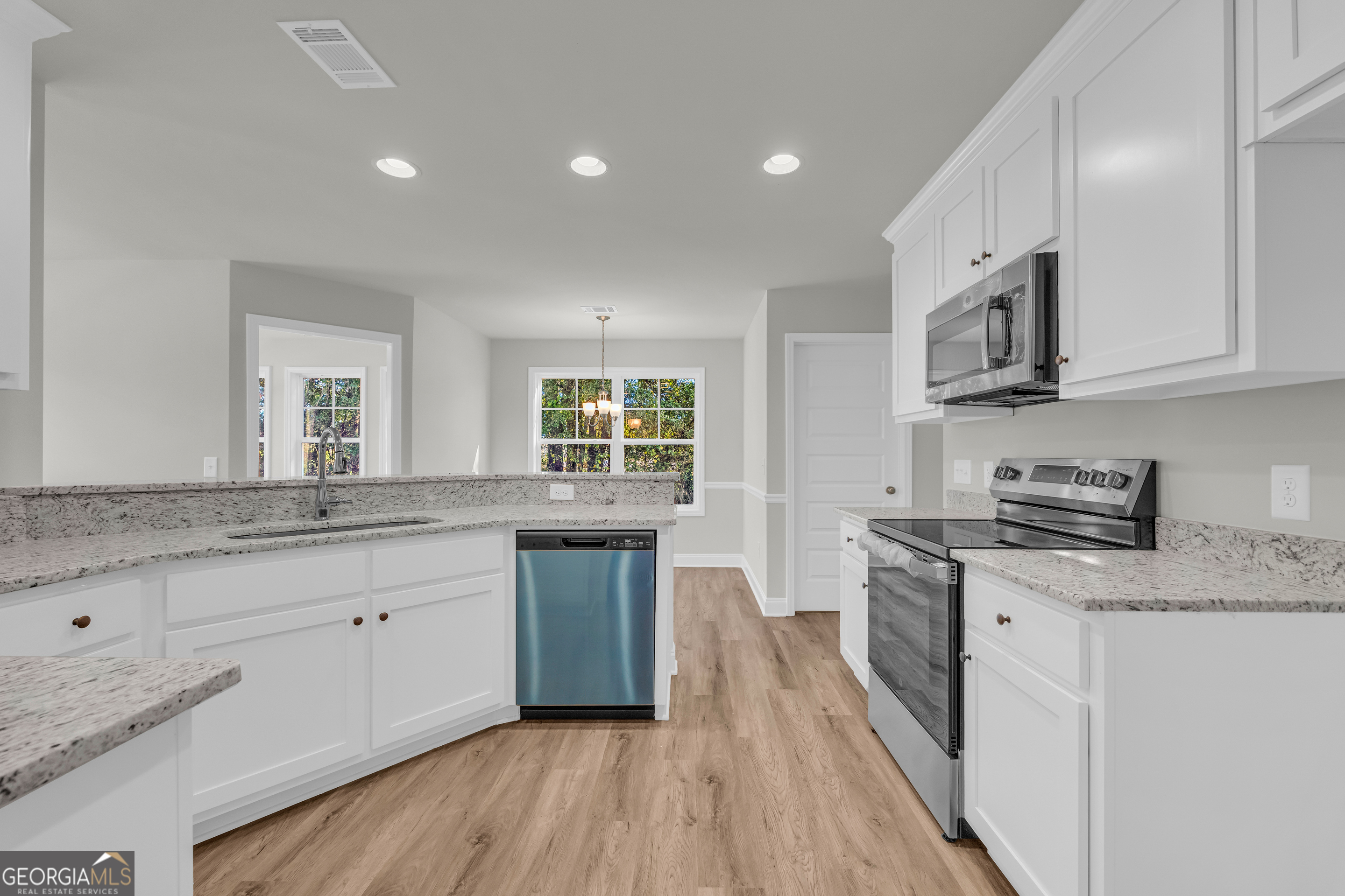 40 Sewell Road Lavonia, GA 30553 - Photo 11 of 29 a kitchen with granite countertop a sink stove and cabinets