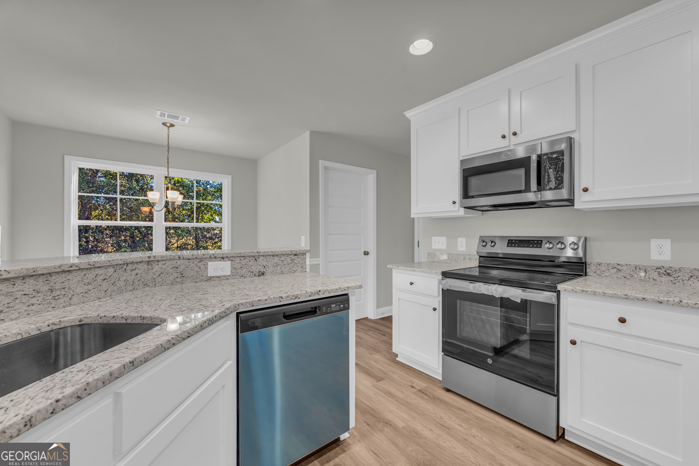 40 Sewell Road Lavonia, GA 30553 - Photo 12 of 29 a kitchen with granite countertop a sink stainless steel appliances and cabinets