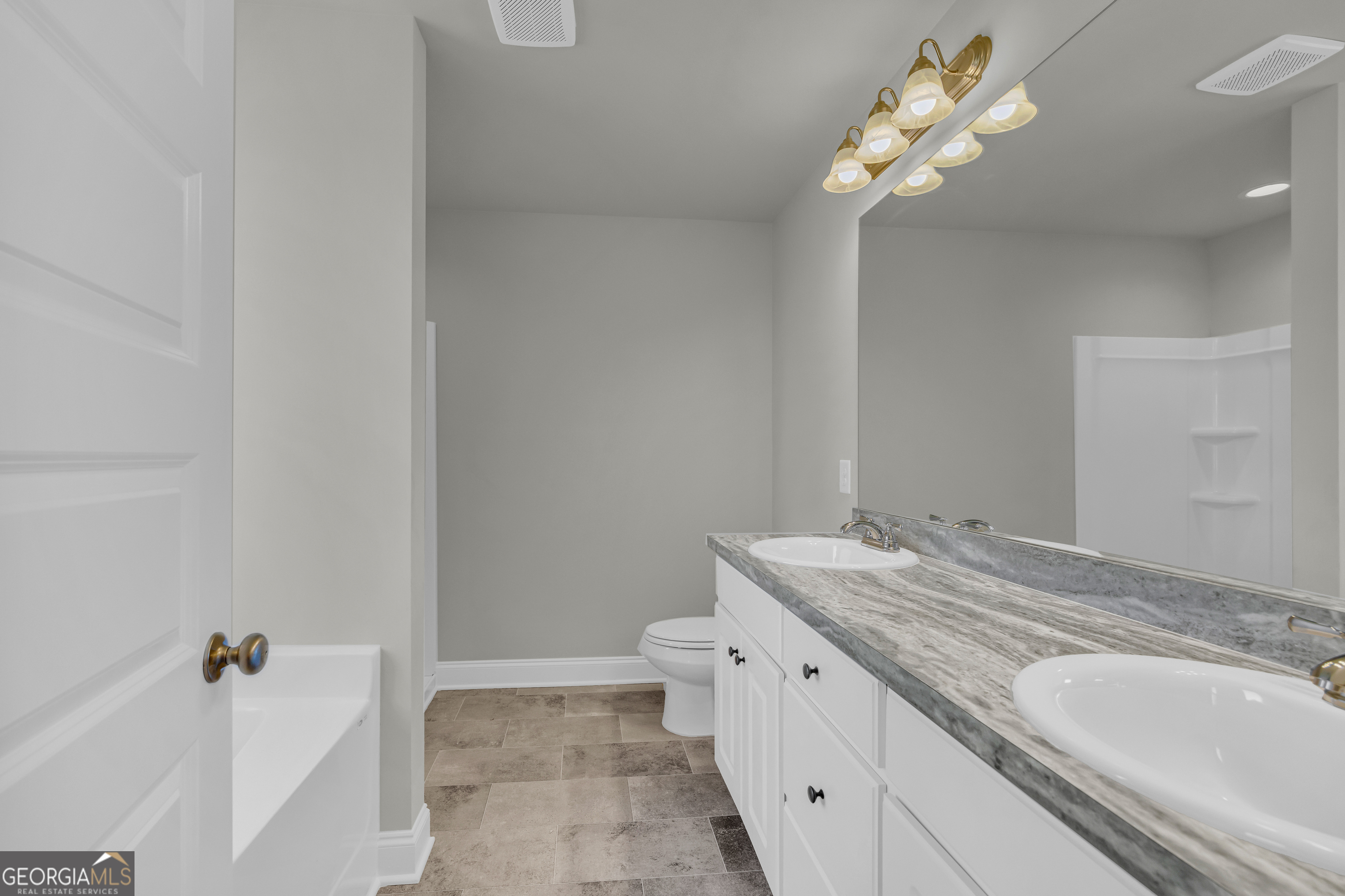 40 Sewell Road Lavonia, GA 30553 - Photo 15 of 29 a bathroom with a granite countertop sink a toilet and a mirror