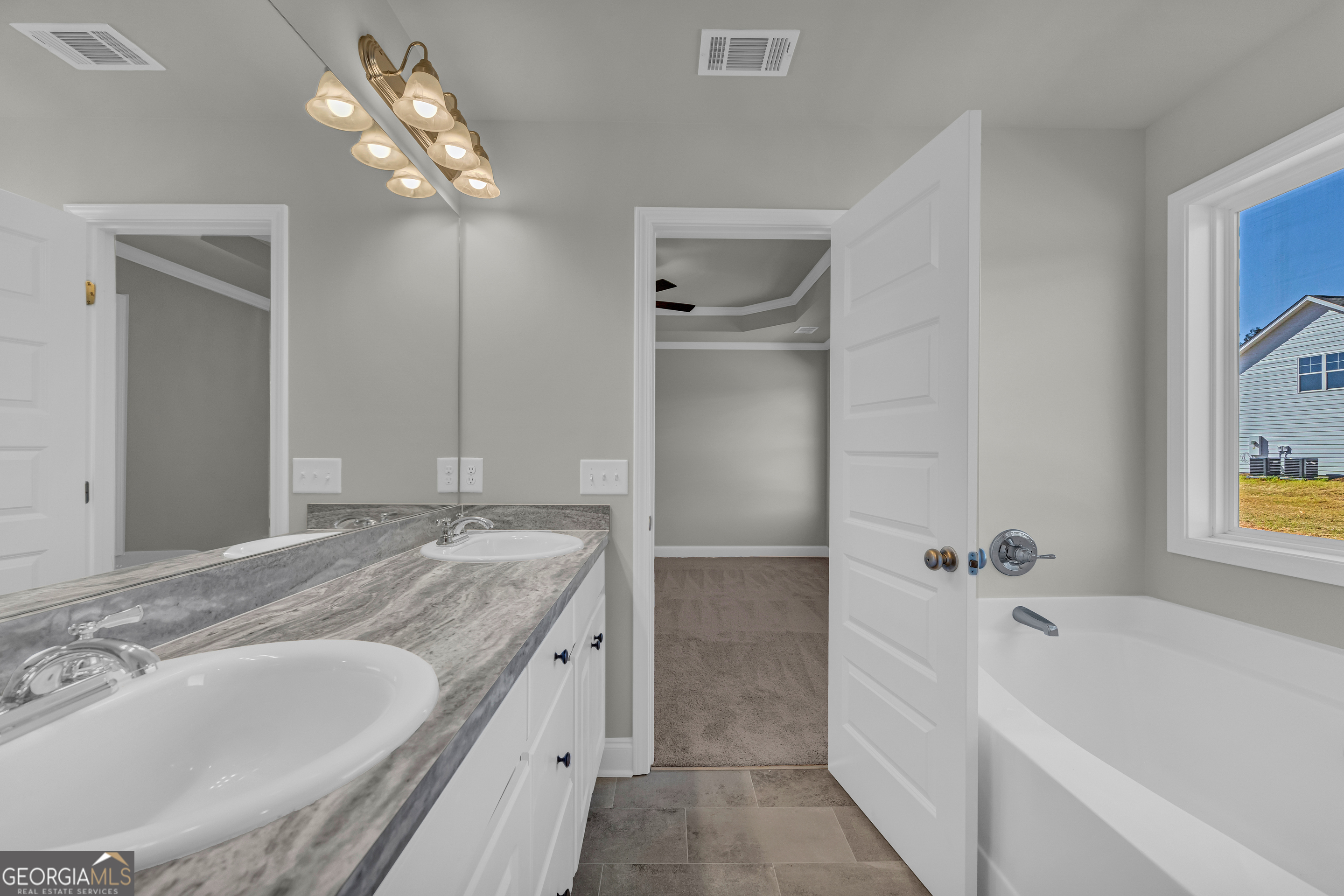 40 Sewell Road Lavonia, GA 30553 - Photo 16 of 29 a bathroom with a granite countertop bathtub a sink and a mirror