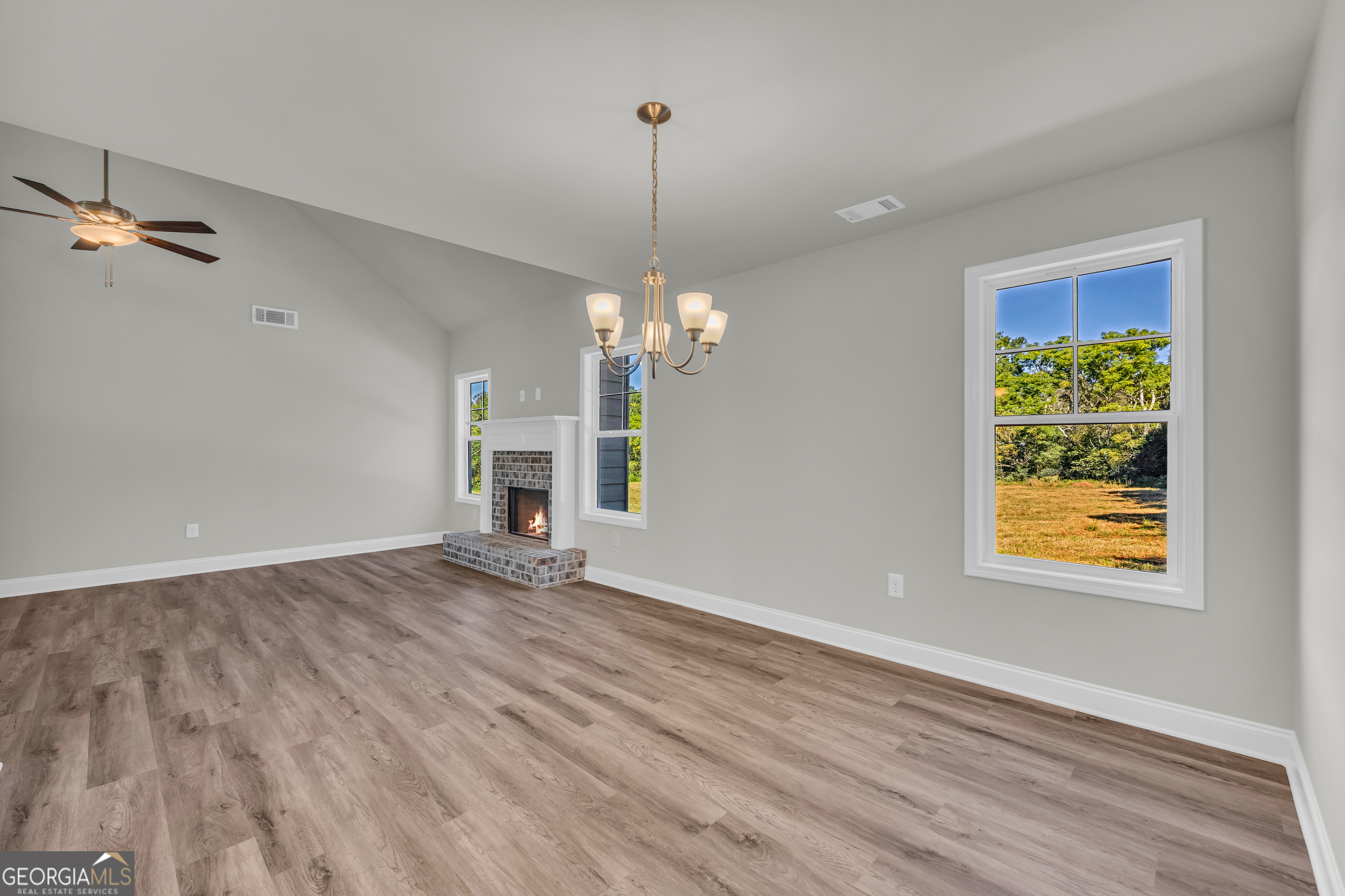 40 Sewell Road Lavonia, GA 30553 - Photo 3 of 29 a view of a room with wooden floor ceiling fan and window