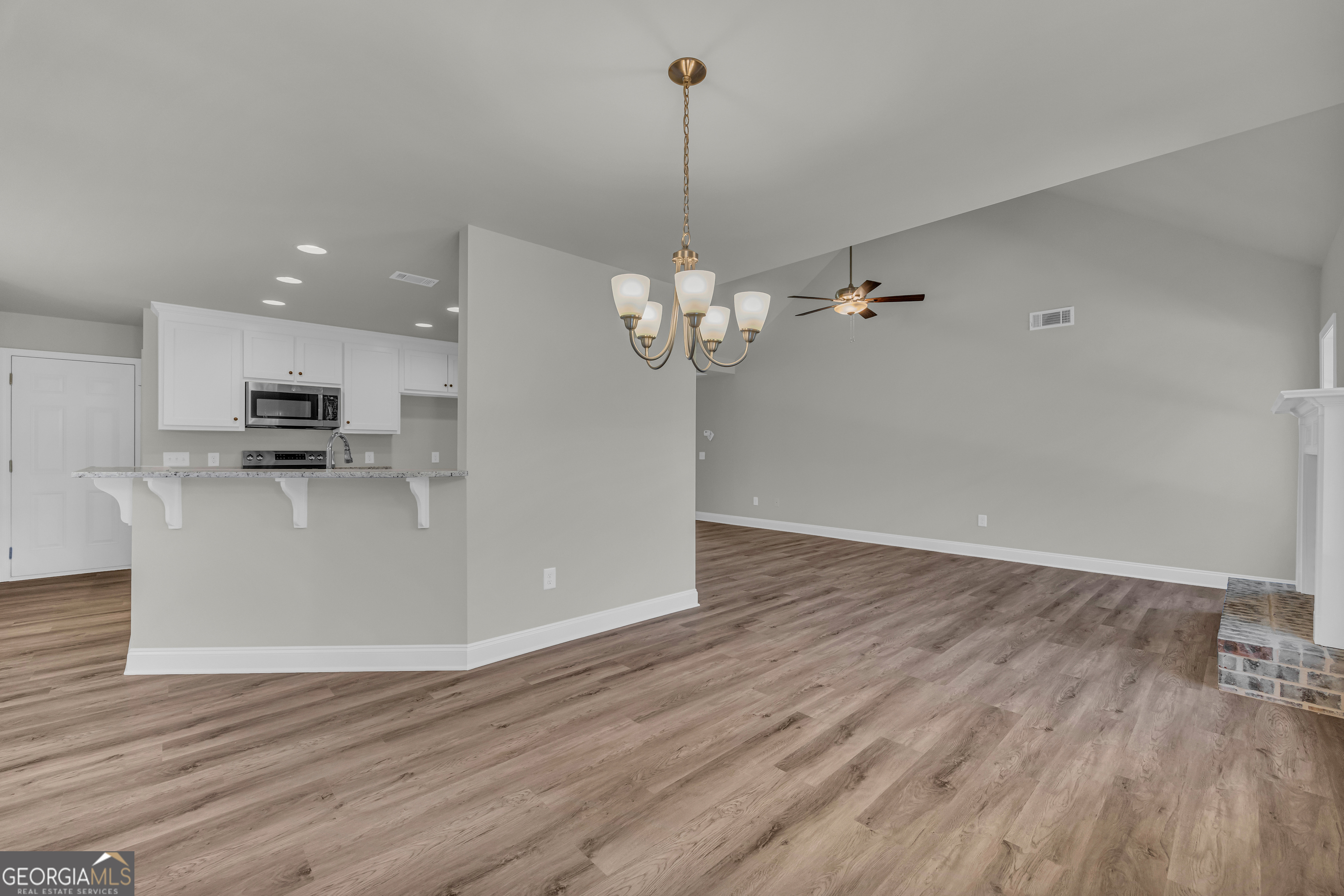 40 Sewell Road Lavonia, GA 30553 - Photo 4 of 29 a view of a room with wooden floor kitchen and windows