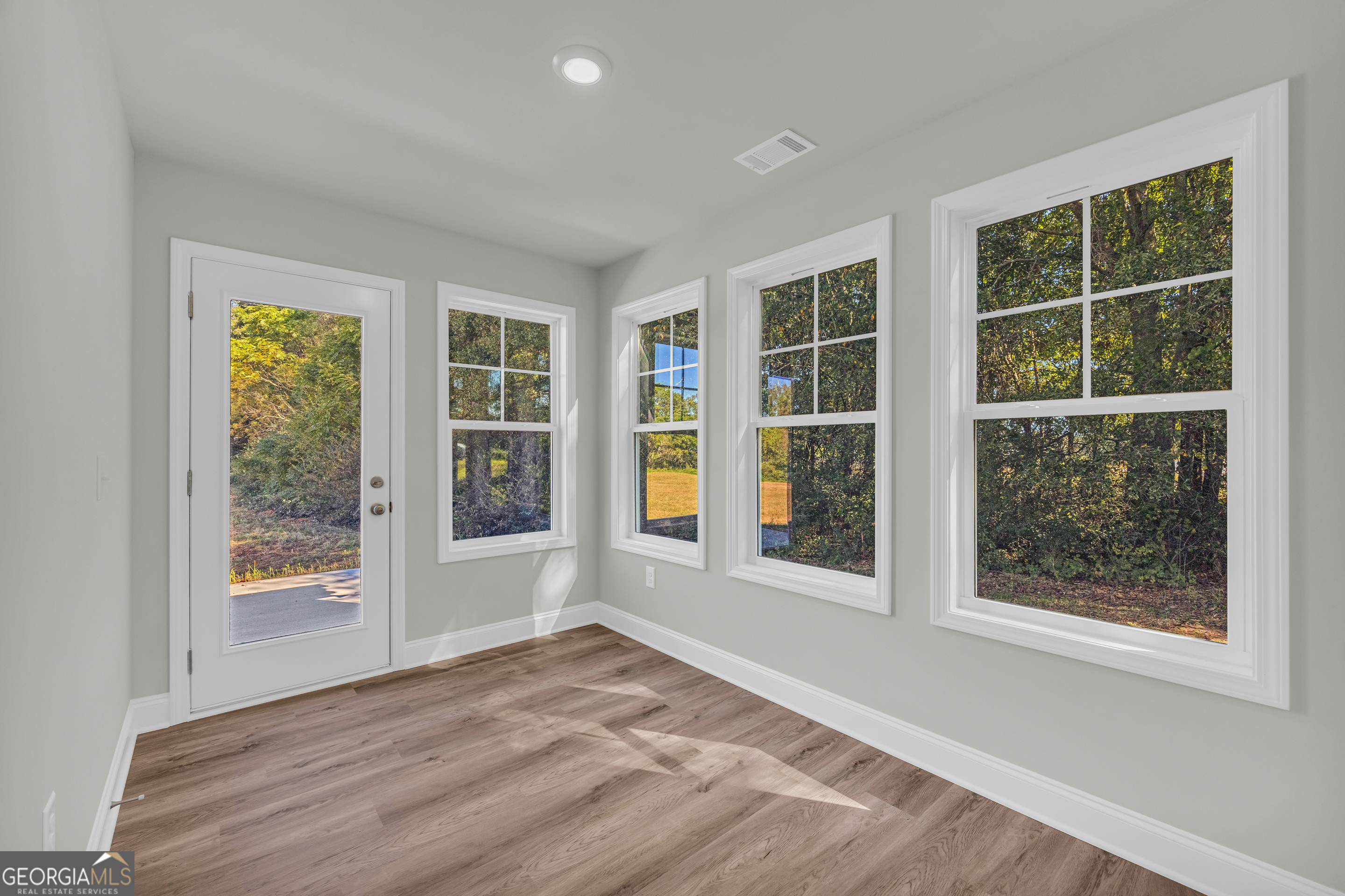 40 Sewell Road Lavonia, GA 30553 - Photo 6 of 29 an empty room with wooden floor and windows