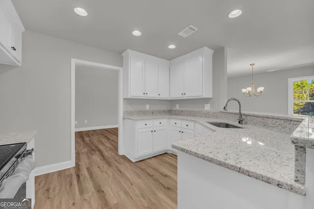 a kitchen with sink and cabinets