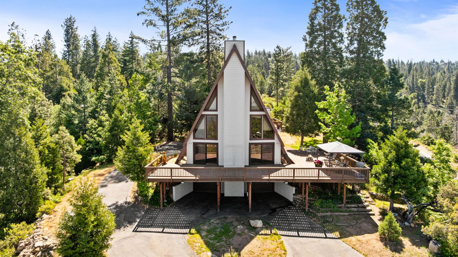38303 Woodland Road Shaver Lake, CA 93664 - Photo 2 of 28 an aerial view of a house with swimming pool and sitting area