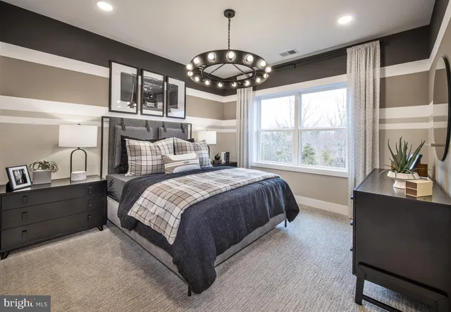 a bedroom with a large bed and a large window