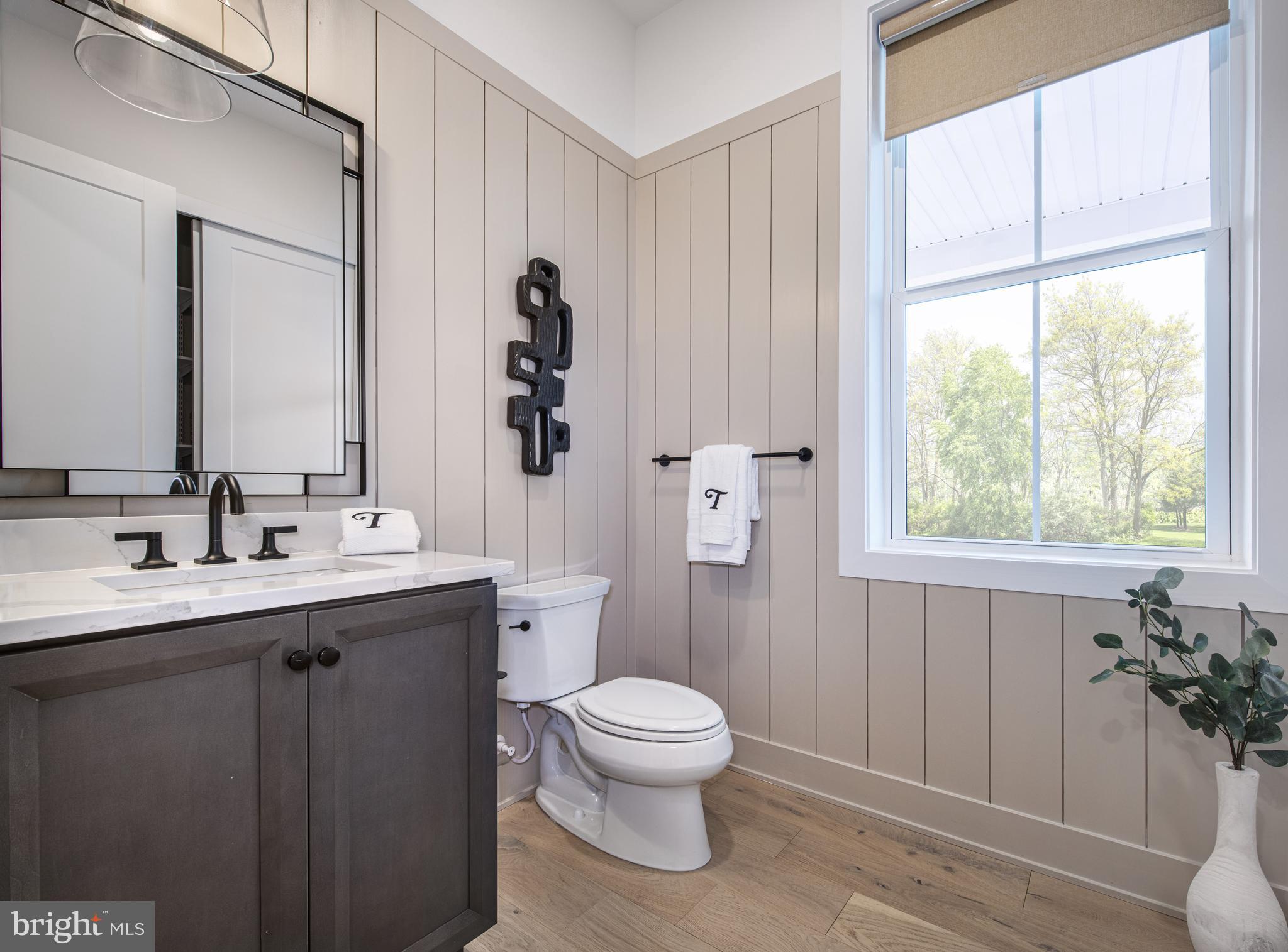 Augusta Drive, Unit ROLLINS Newtown, PA 18940 - Photo 7 of 14 a bathroom with a toilet a sink and a mirror