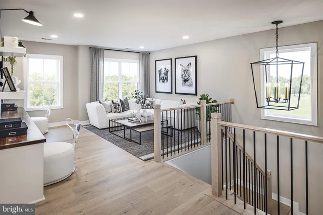a living room with furniture a window and wooden floor