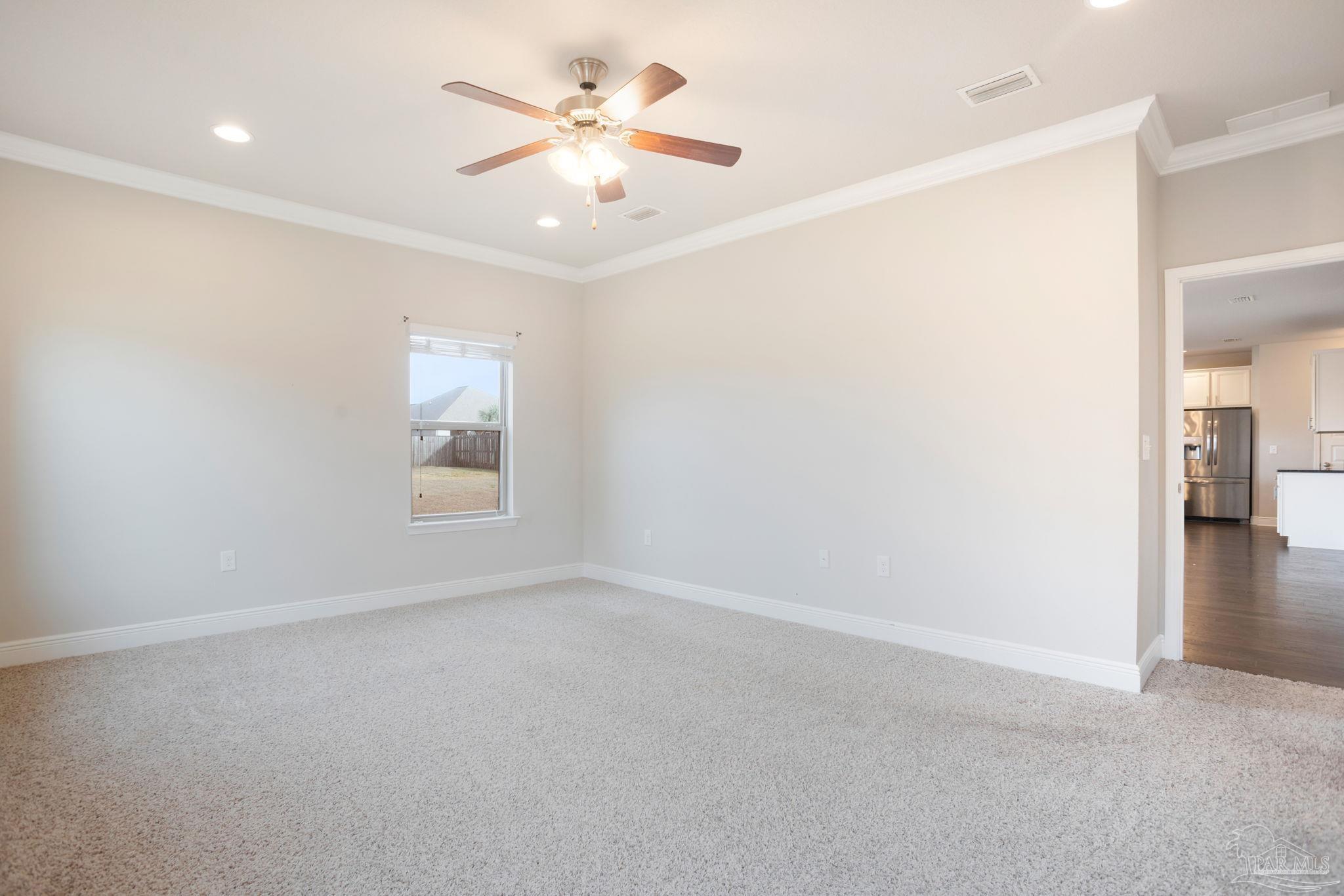 8016 Woodbrook Road Pensacola, FL 32526 - Photo 17 of 52 en empty room with windows and ceiling fan