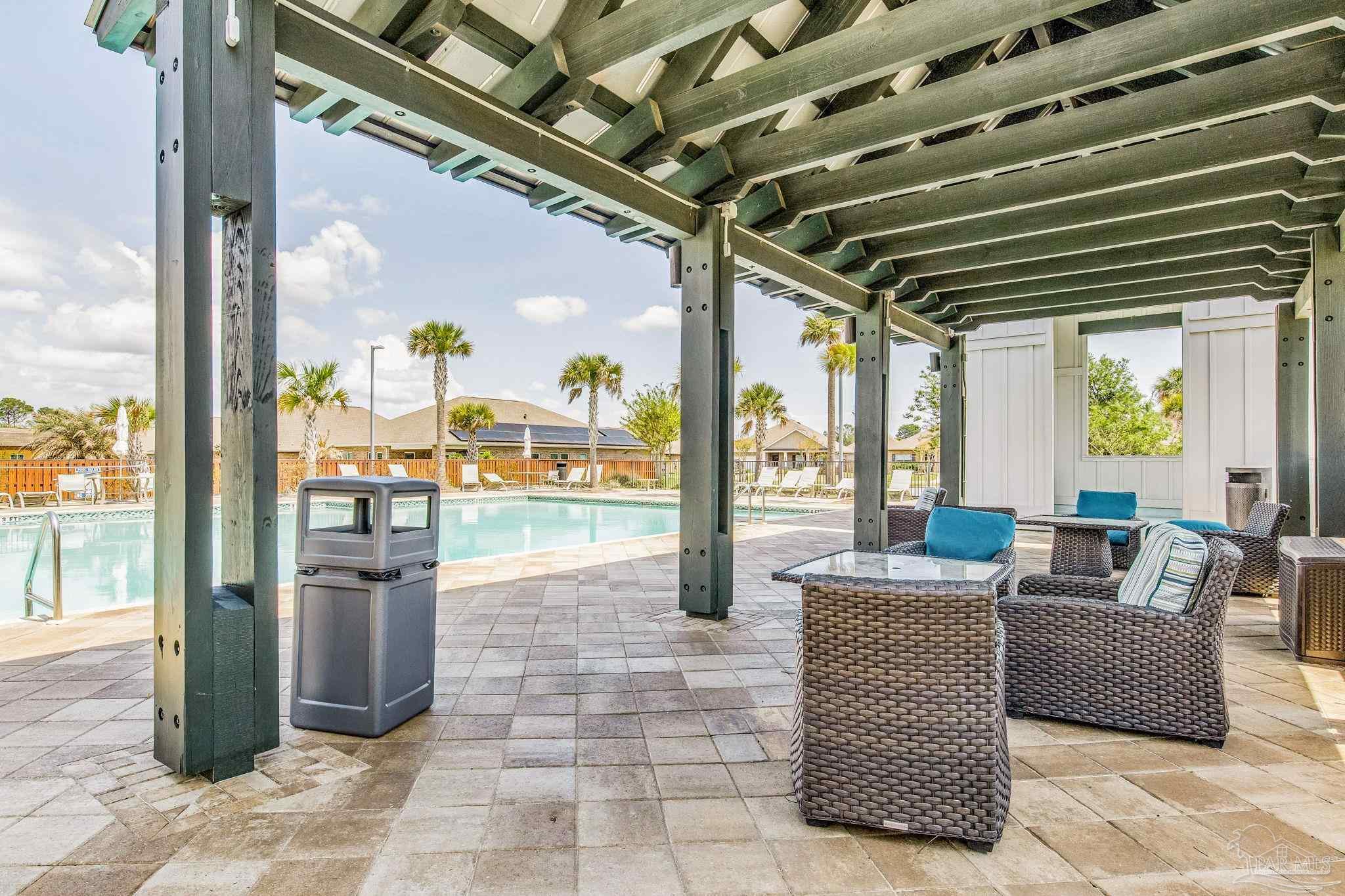 8016 Woodbrook Road Pensacola, FL 32526 - Photo 51 of 52 a outdoor space with the couches and dining table with the garden view