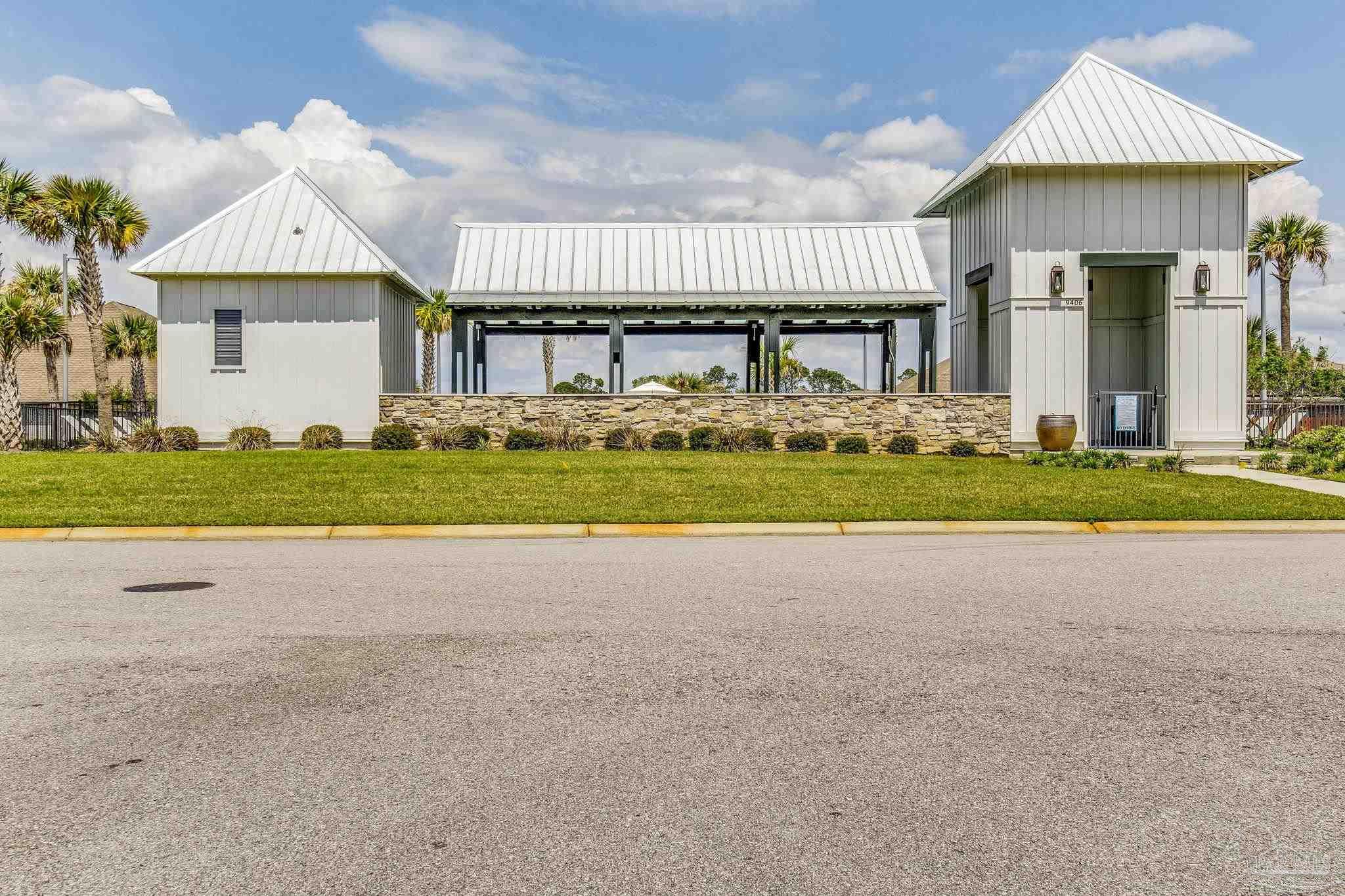 8016 Woodbrook Road Pensacola, FL 32526 - Photo 52 of 52 a front view of a house with a garden and trees