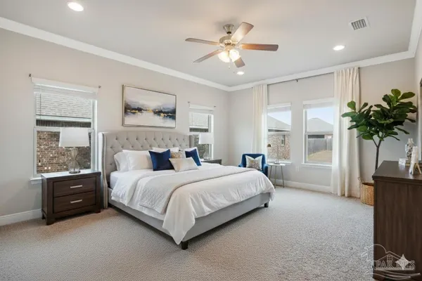 a living room with couches and kitchen view with wooden floor