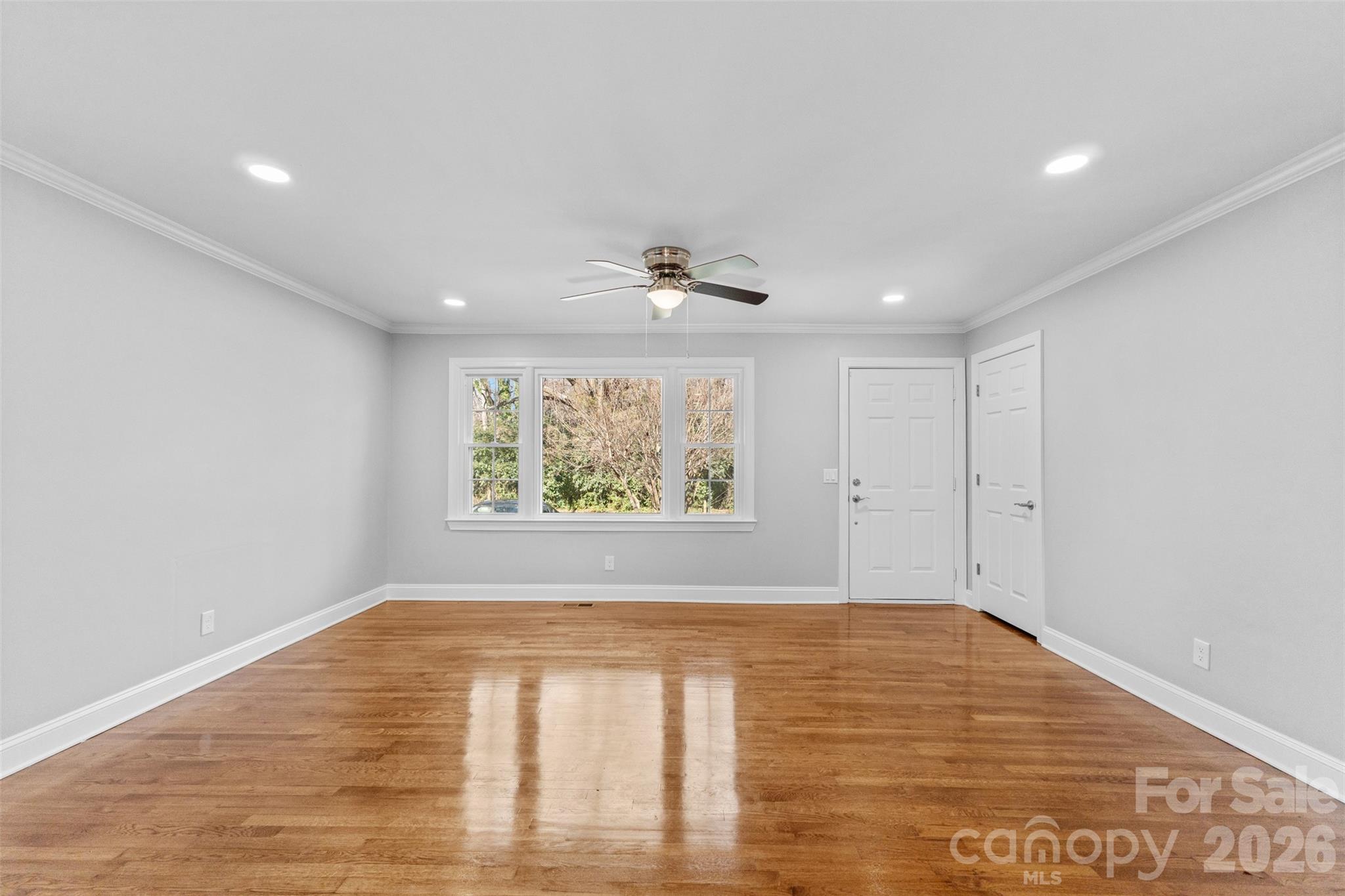 206 Hunter Street York, SC 29745 - Photo 5 of 20 a view of an empty room with wooden floor and a window