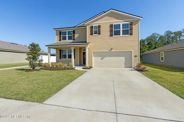 a kitchen with stainless steel appliances a sink dishwasher a refrigerator and white cabinets with wooden floor