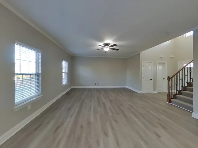 wooden floor in an empty room with a window