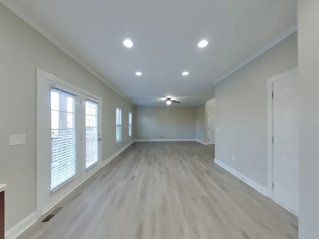 wooden floor in an empty room with a window