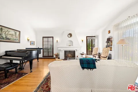 a living room with furniture a fireplace and a window