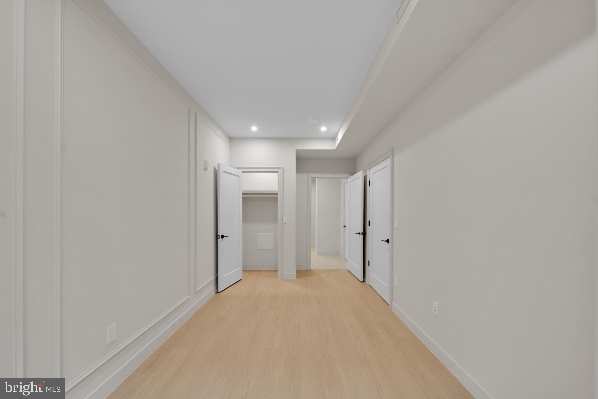2121 Ward Place Northwest, Unit 402 Washington, DC 20037 - Photo 11 of 21 a view of a big room with closet and wooden floor