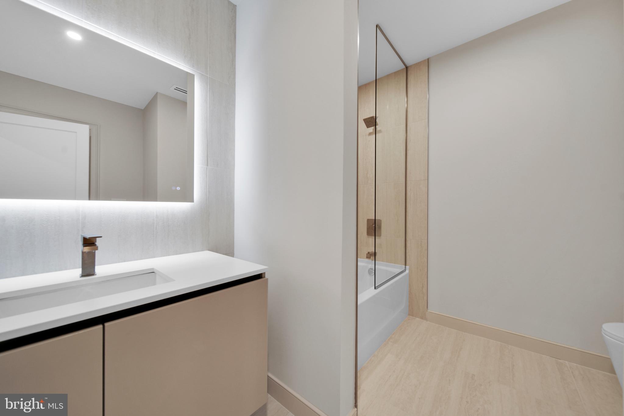 2121 Ward Place Northwest, Unit 402 Washington, DC 20037 - Photo 14 of 21 a bathroom with a sink and a mirror