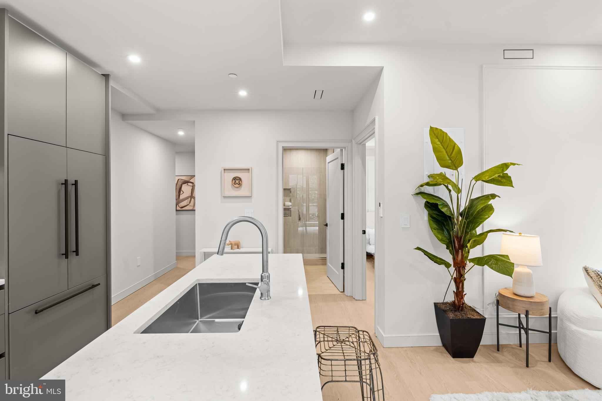 2121 Ward Place Northwest, Unit 402 Washington, DC 20037 - Photo 5 of 19 a living room with furniture and a potted plant