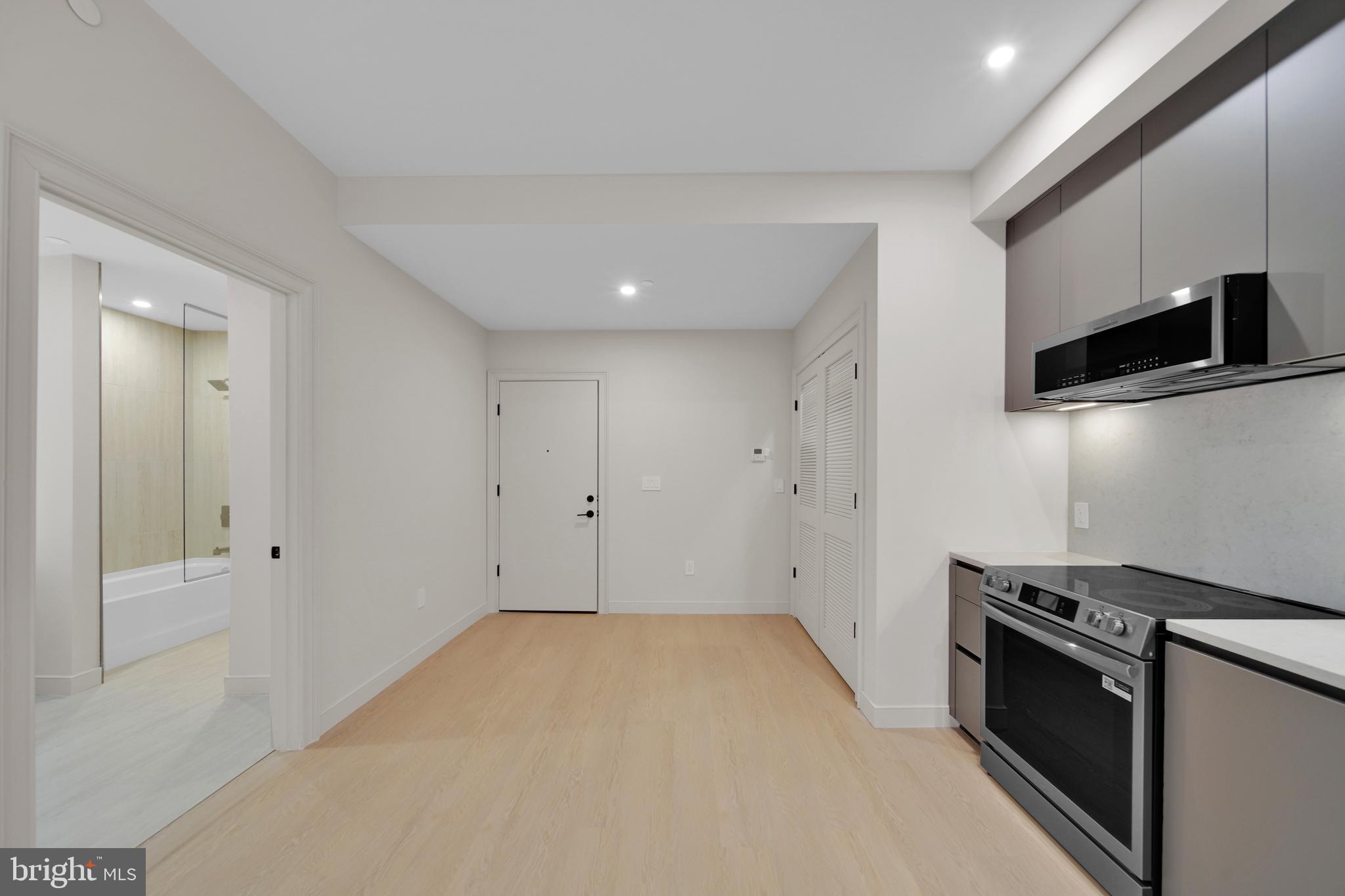 2121 Ward Place Northwest, Unit 402 Washington, DC 20037 - Photo 6 of 18 a view of kitchen with cabinets and wooden floor
