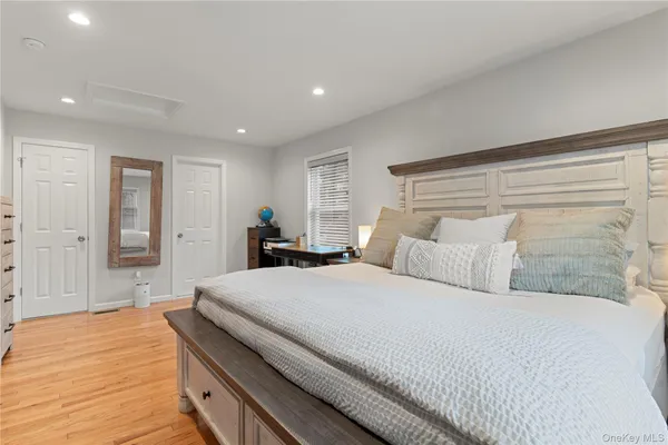 a bedroom with a large bed and a chandelier