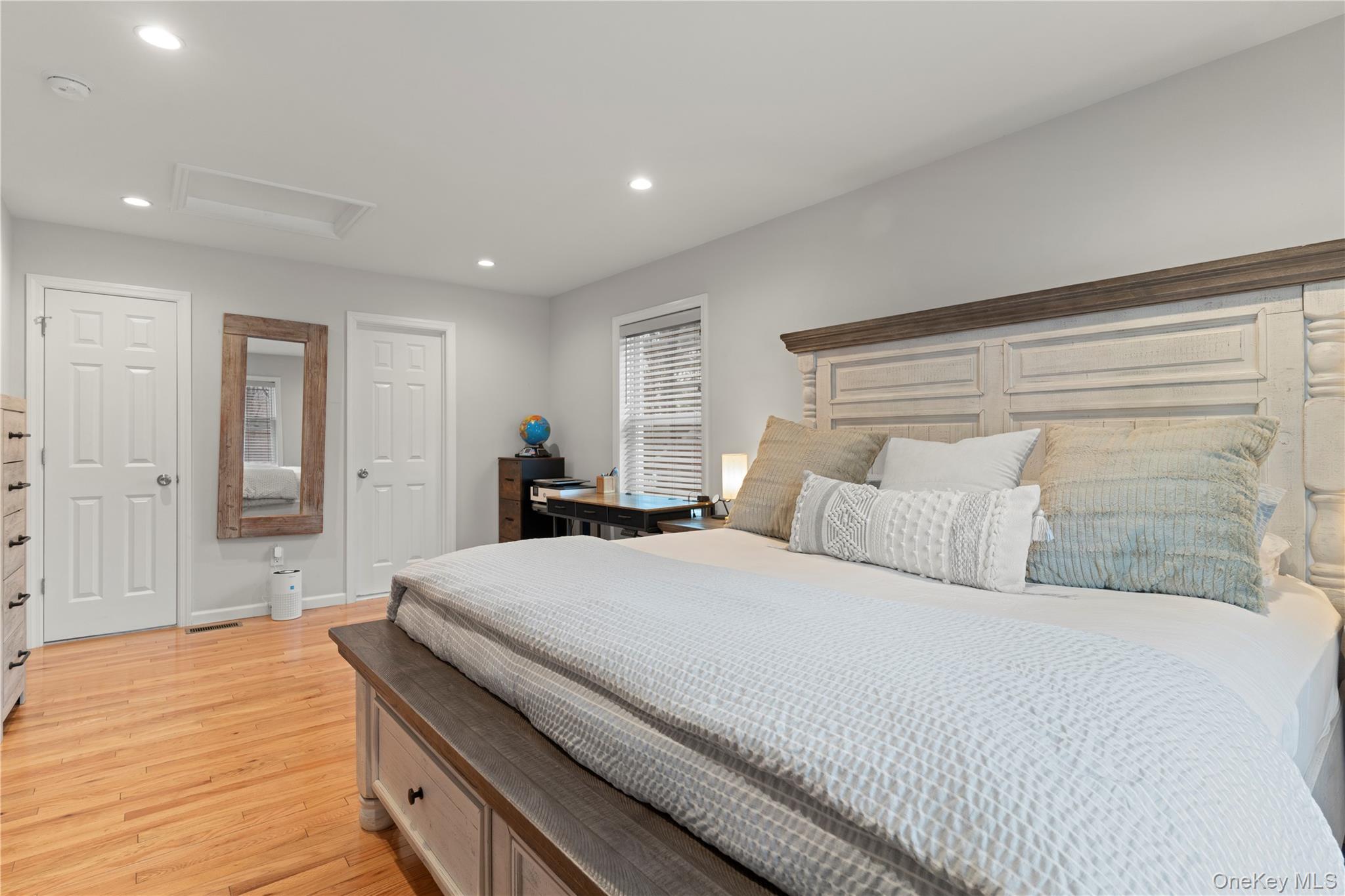 65 Beaver Road LaGrangeville, NY 12540 - Photo 12 of 40 a bedroom with a large bed and a chandelier