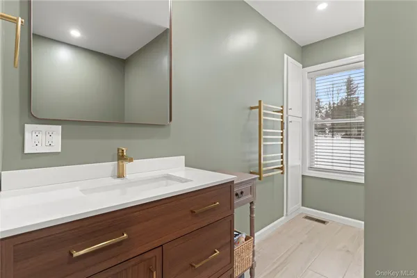 a bathroom with a sink a vanity and a mirror