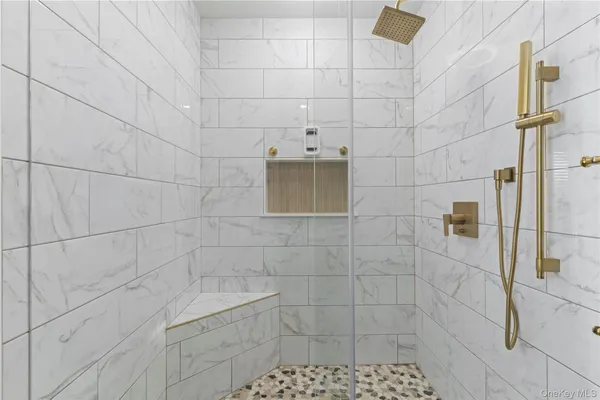 a en suite bathroom with a sink a mirror and shower