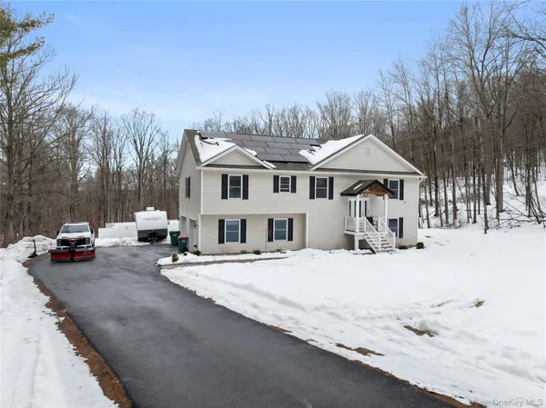 a view of a house with snow on the road