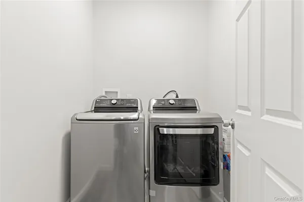 a bedroom with furniture a flat screen tv and a window