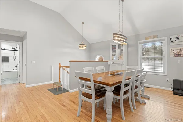 a dining room with a wooden table and chairs
