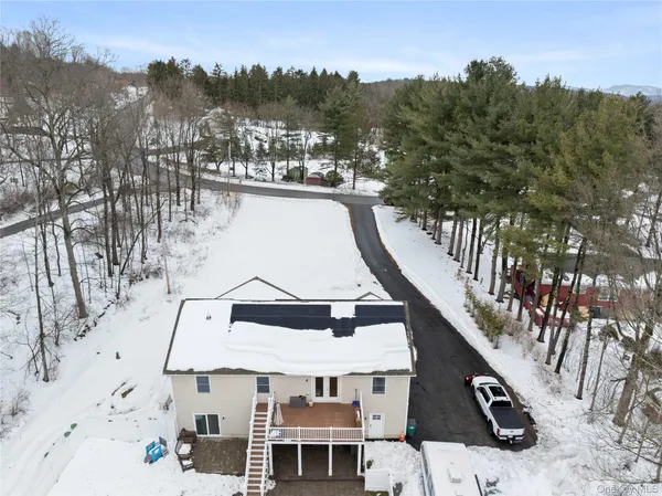 a view of living room with furniture and large window