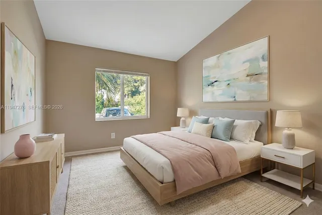 a bedroom with a bed and a painting on the wall